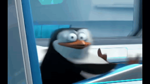 A Penguin From Madagascar Is Sitting In A Chair And Making A Funny Face GIF