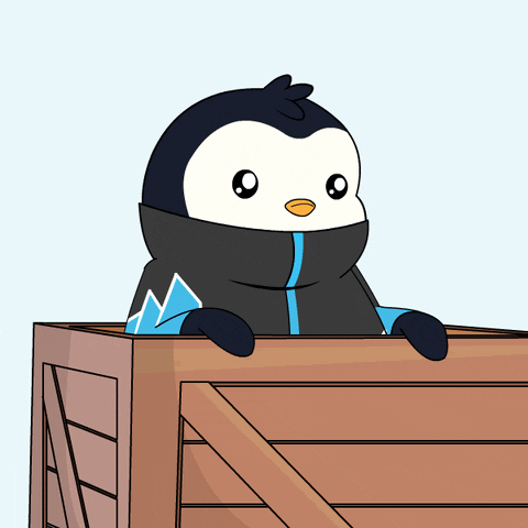 A Penguin In A Black And Blue Jacket Is Peeking Out Of A Wooden Box GIF