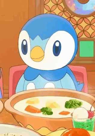 a penguin is sitting at a table with a bowl of soup and a cup of ice cream .