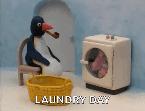 A Penguin Is Sitting In A Chair Next To A Washing Machine With The Words Laundry Day Written On The Bottom GIF