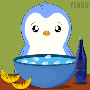 A Penguin Is Sitting Next To A Bowl Of Ice And Bananas GIF