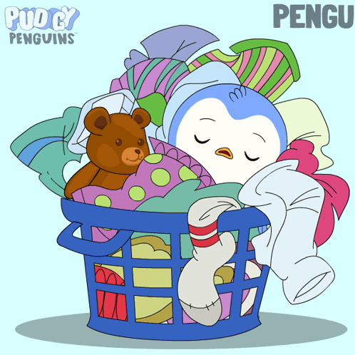 A Penguin Is Sleeping In A Laundry Basket With Clothes And A Teddy Bear GIF