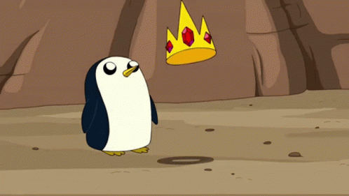 a penguin is standing next to a crown with ruby stones on it