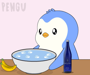A Penguin Is Taking A Bath In A Bowl Of Water GIF
