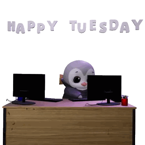 a penguin sits at a desk in front of two computer monitors with the words happy tuesday above him