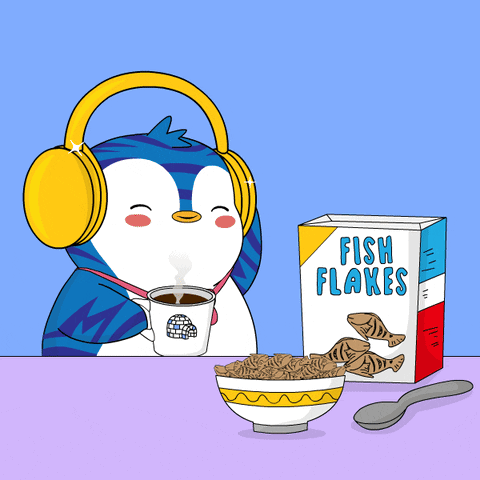 A Penguin Wearing Headphones Sits At A Table With A Bowl Of Fish Flakes And A Box Of Fish Flakes GIF