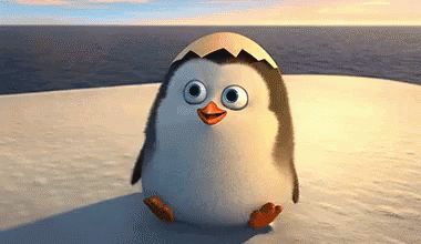 A Penguin With An Egg On Its Head Is Standing On A Snow Covered Island . GIF