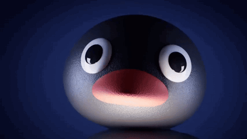 A Penguin With Big Eyes And A Red Beak GIF
