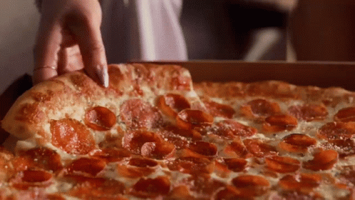 A Pepperoni Pizza With Cheese And Pepperoni Slices GIF