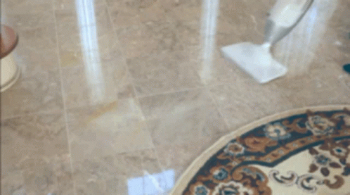 A Person Cleaning A Rug With A Mop On The Floor GIF