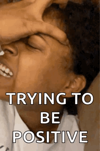 A Person Covering Their Face With Their Hand And The Words Trying To Be Positive On The Bottom GIF