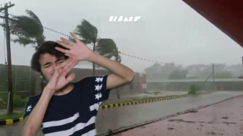A Person Covering Their Face With Their Hands In Front Of A Sign That Says Hump GIF