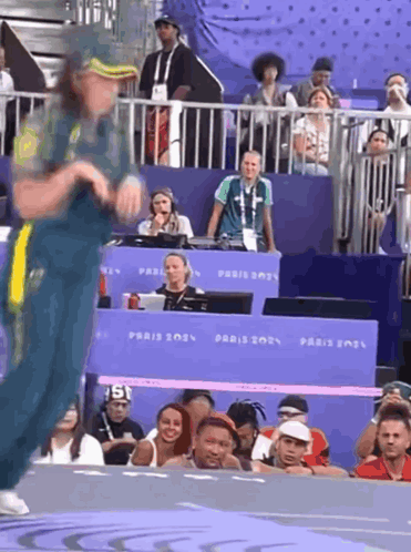 A Person Dancing In Front Of A Sign That Says Paris 202 GIF