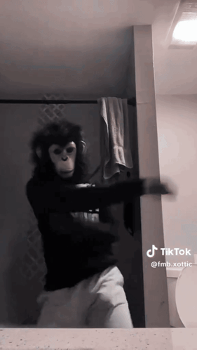 A Person Dressed As A Monkey Is Dancing In Front Of A Mirror GIF