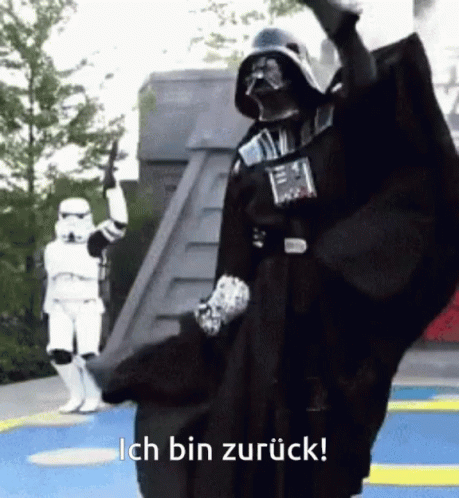 A Person Dressed As Darth Vader With The Words Ich Bin Zurück Below Him GIF