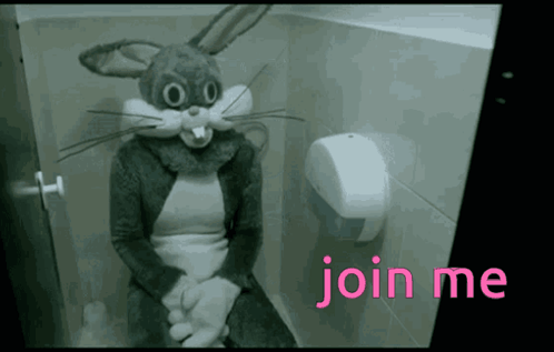 A Person Dressed In A Bunny Costume Is Sitting On A Toilet GIF