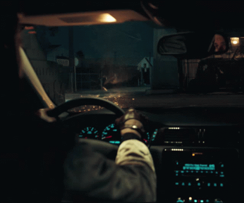 A Person Driving A Car At Night With A Sign That Says ' A ' On The Side GIF