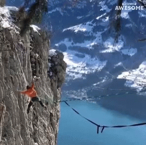 A Person Hanging From A Rope On A Cliff With The Words " Awesome " Above Them GIF