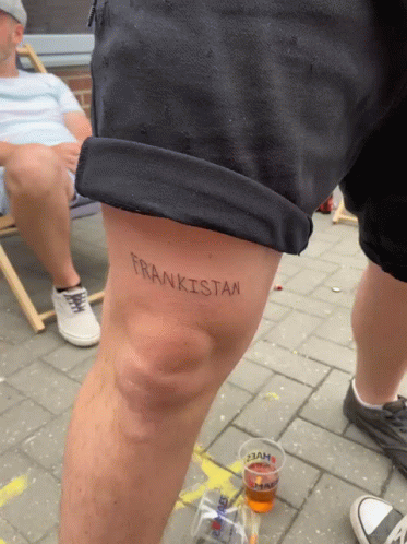 A Person Has A Tattoo On Their Knee That Says Frankistan GIF