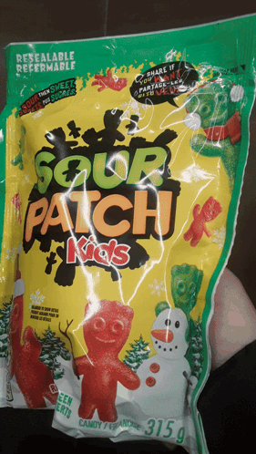 A Person Holding A Bag Of Sour Patch Kids GIF
