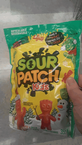 A Person Holding A Bag Of Sour Patch Kids GIF