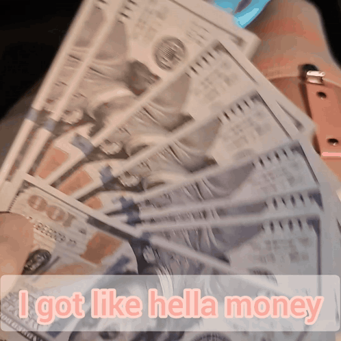 A Person Holding A Bunch Of Money With The Words " I Got Like Hella Money " On The Bottom GIF