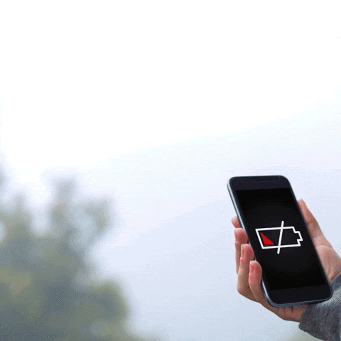 A Person Holding A Cell Phone With A Low Battery Icon On The Screen GIF