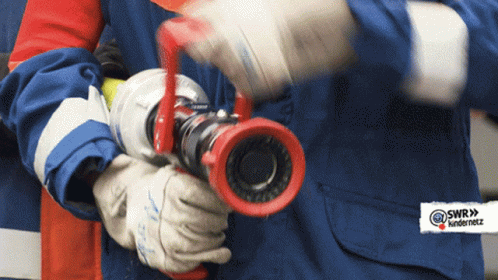 A Person Holding A Fire Hose With A Sticker That Says @Swr9 Underneath GIF