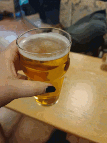 A Person Holding A Glass Of Beer With Black Nails GIF