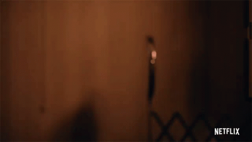 Person Holding Gun With Netflix Logo Background GIF