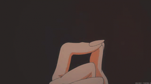 A Person Holding A Heart In Their Hands With A Dark Background GIF