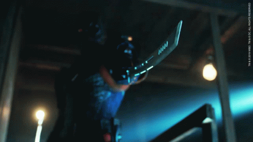 A Person Holding A Hockey Stick With The Letters Tm On The Bottom GIF