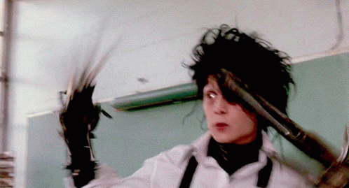 A Person Holding A Pair Of Scissors And A Hammer GIF