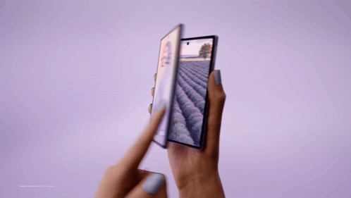A Person Holding A Phone With A Field On The Screen GIF