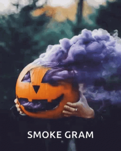 A Person Holding A Pumpkin With Smoke Coming Out Of It And The Words Smoke Gram Below It GIF