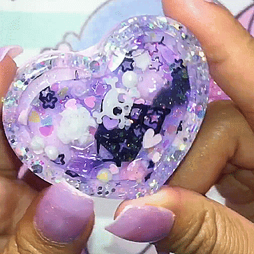 a person holding a purple heart shaped object