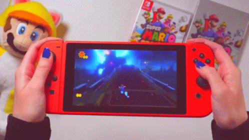 A Person Holding A Red Nintendo Switch With A Super Mario Game On The Screen GIF