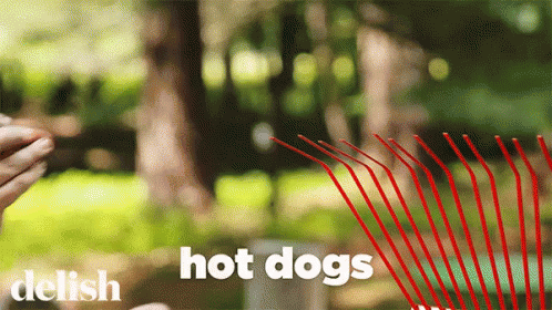 A Person Holding A Red Straw With The Words Hot Dogs Written On It GIF