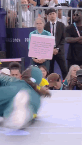 A Person Holding A Sign That Says " Paris 2019 " GIF