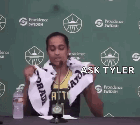 A Person Holding A Towel In Front Of A Providence Swedish Banner GIF