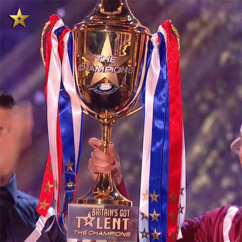 A Person Holding A Trophy That Says Britain 'S Got Talent GIF