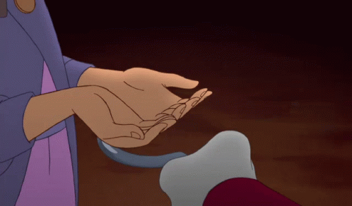 a person holding another person 's hand in a dark room