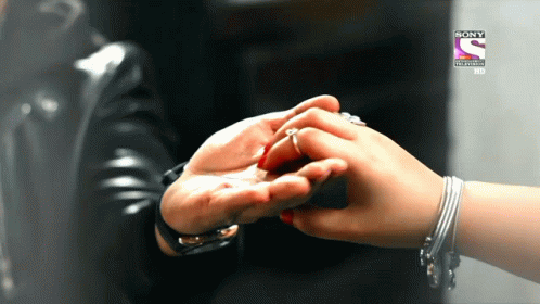 a person holding another person 's hand in front of a sony television logo
