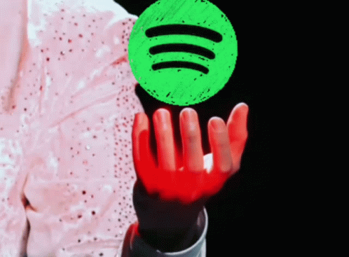 A Person Holding Up A Green Spotify Logo GIF