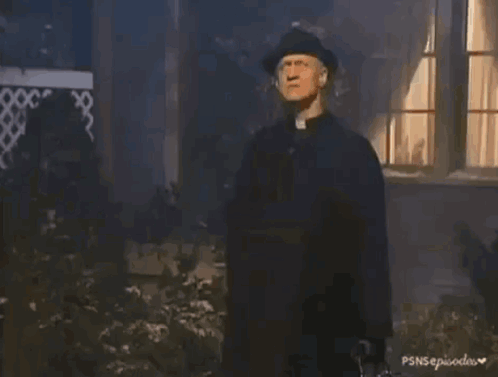 A Person In A Black Glove Is Holding A Small White Bottle With A Cross On It GIF