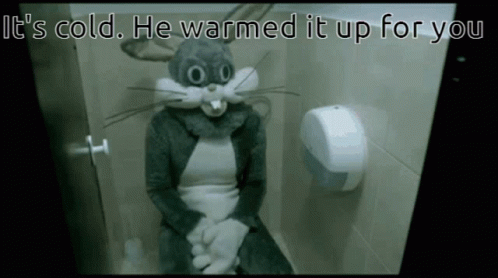 A Person In A Bugs Bunny Costume Is Sitting On A Toilet With The Caption It 'S Cold He Warmed It Up For You GIF