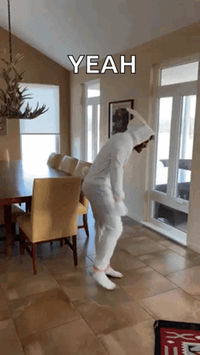 A Person In A Bunny Costume Is Dancing In A Dining Room With A Caption That Says " Yeah " GIF