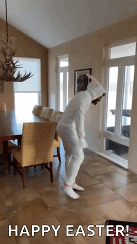 A Person In A Bunny Costume Is Dancing In A Living Room With The Words Happy Easter Written Below It GIF