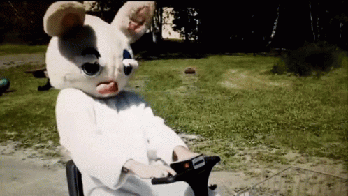 A Person In A Bunny Mask Is Riding A Scooter GIF