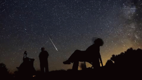 Person Looking At Shooting Star In Chair GIF